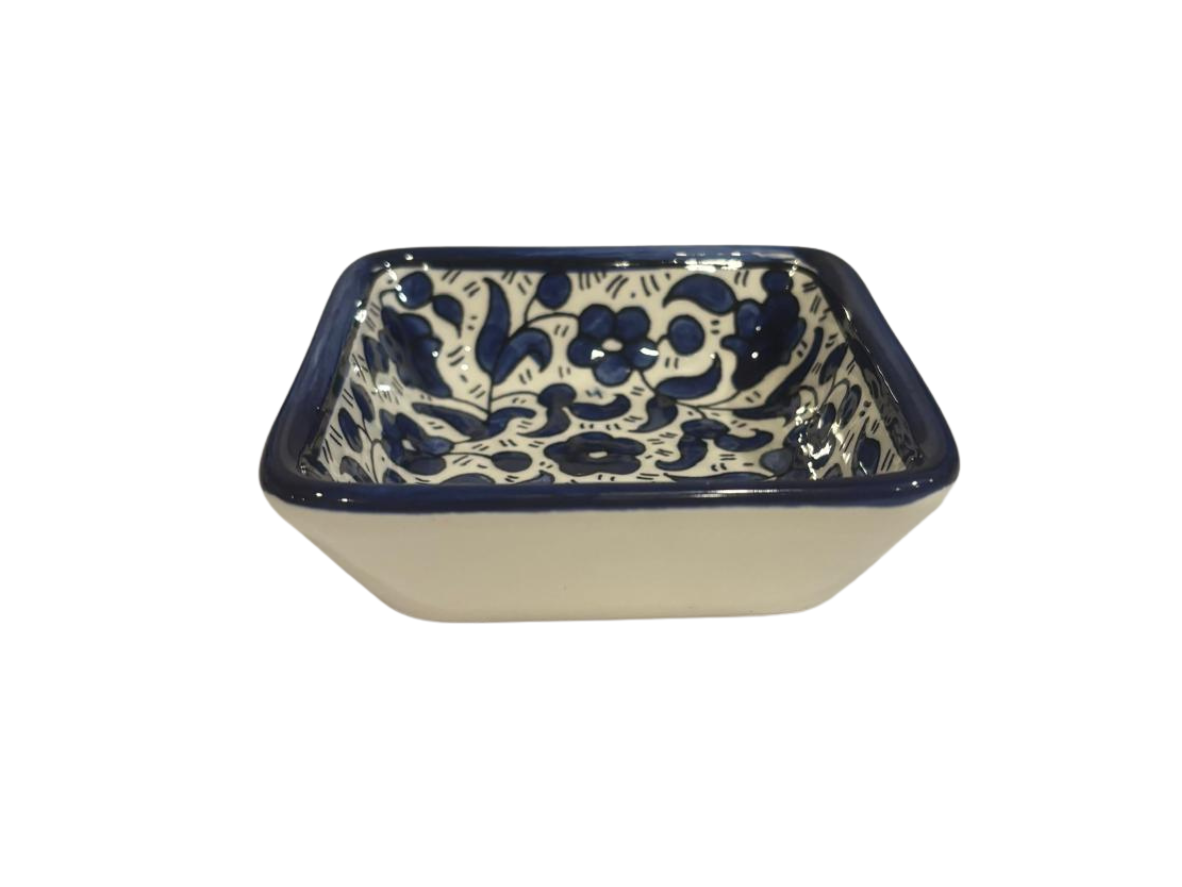 Ceramic bowl with blue floral pattern on a beige background