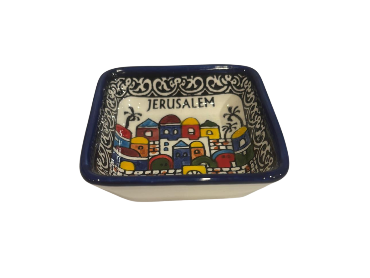 Ceramic dish with 'Jerusalem' text and colorful cityscape design on a white background