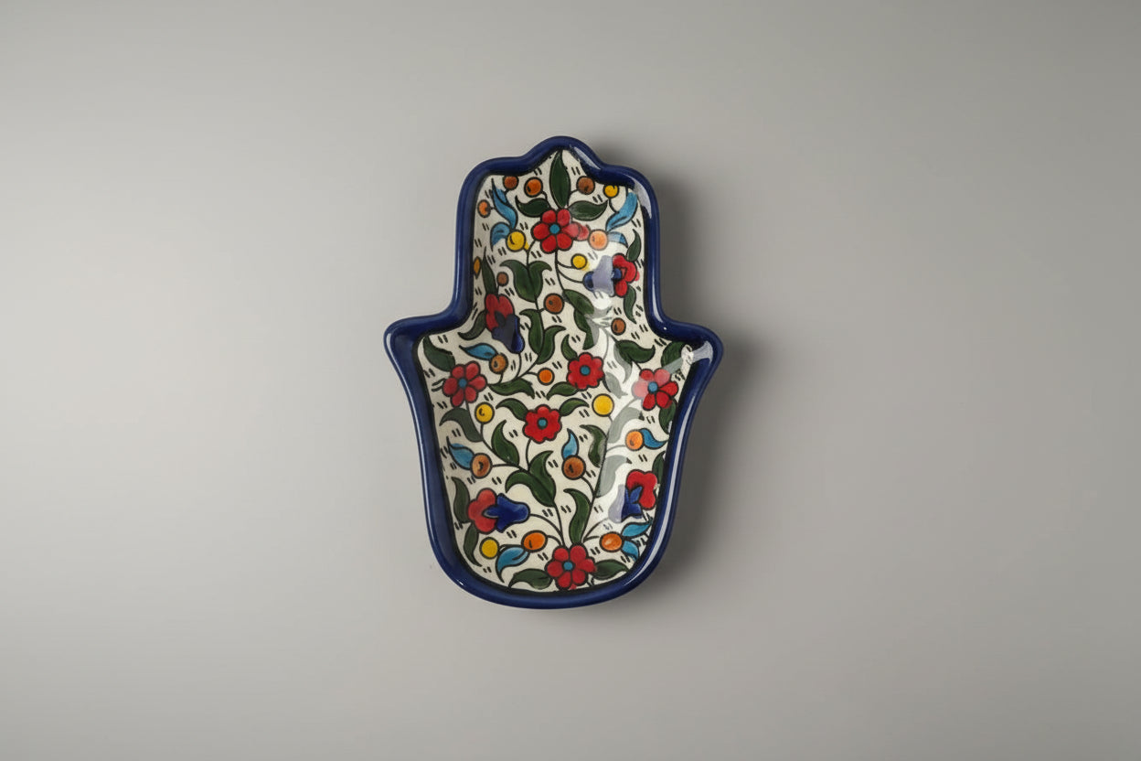 Decorative Hamsa hand with floral pattern on a gray background