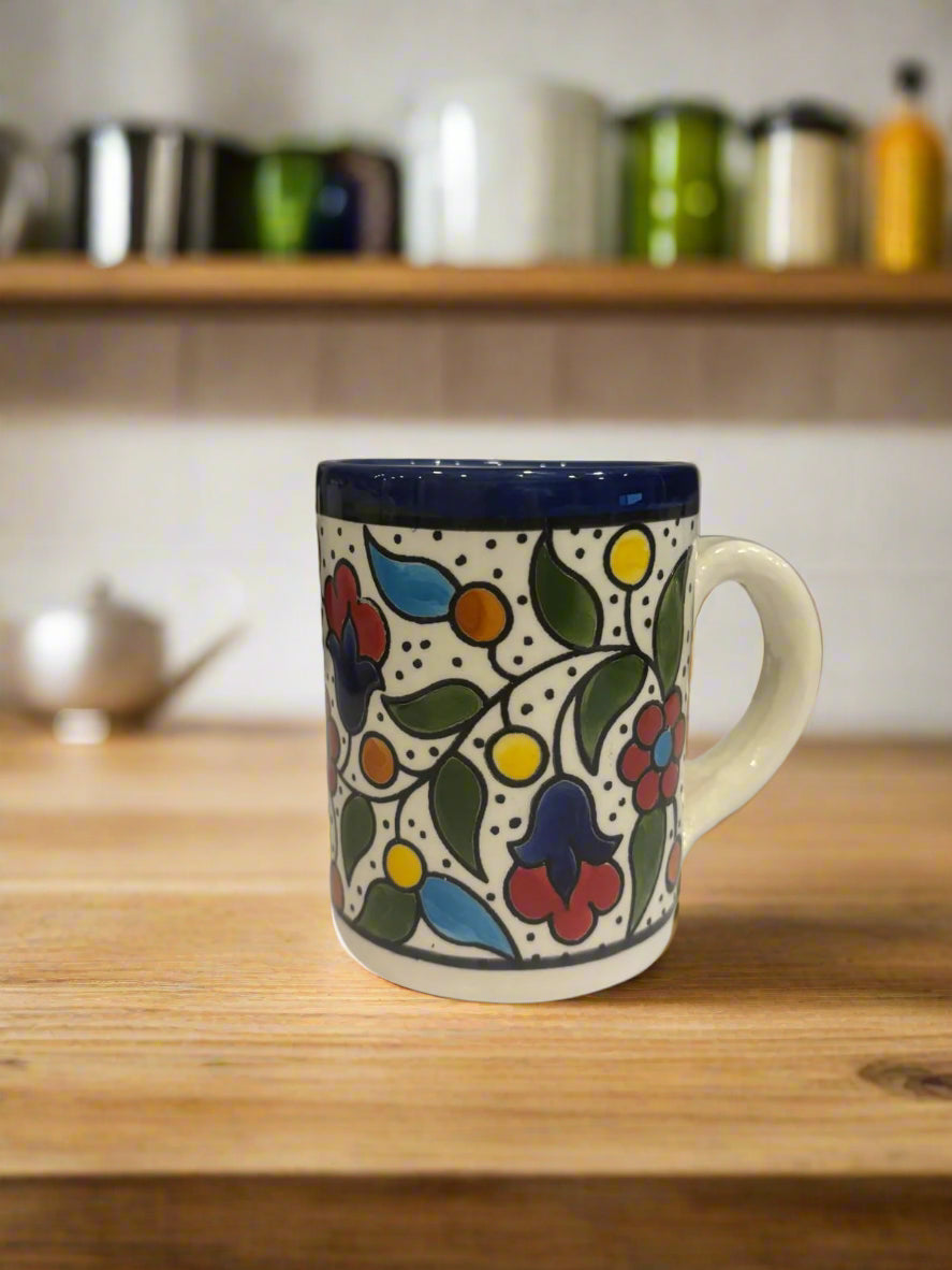 Decorative mug with floral pattern on a wooden surface in a kitchen setting