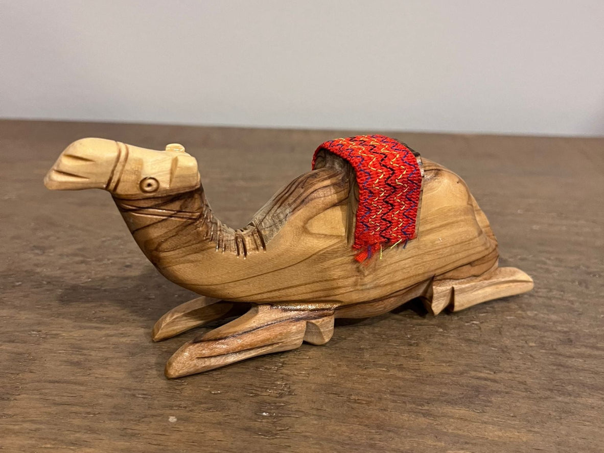Hand-carved olive wood camel figurine with red woven saddle made in Palestine