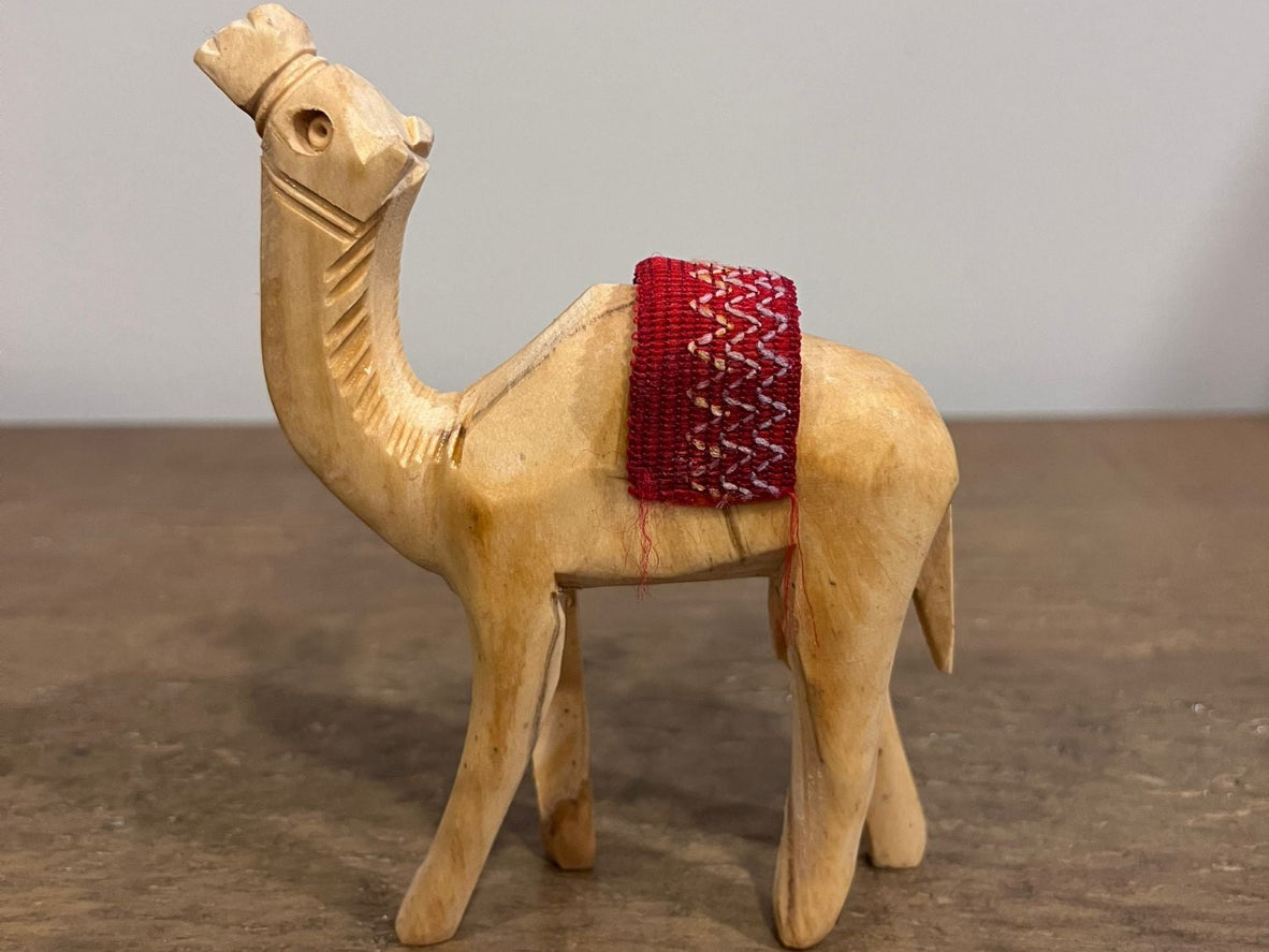 Hand-carved olive wood camel figurine with red woven saddle made in Palestine