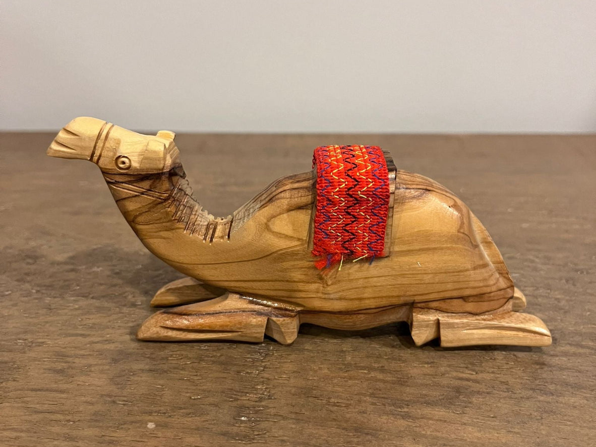 Hand-carved olive wood camel figurine with red woven saddle made in Palestine