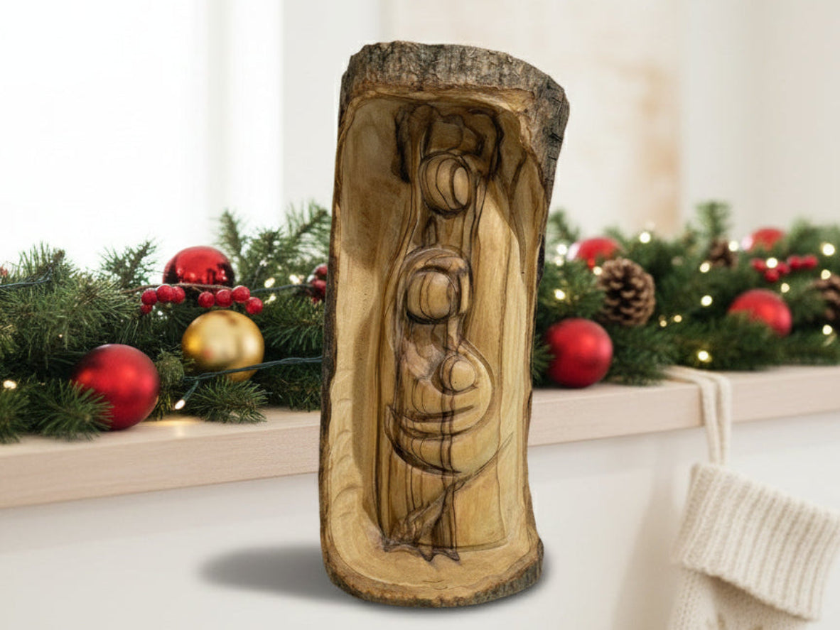 Hand-carved olive wood Holy Family figurine with natural bark exterior, Nativity carving from the Holy Land on wooden table