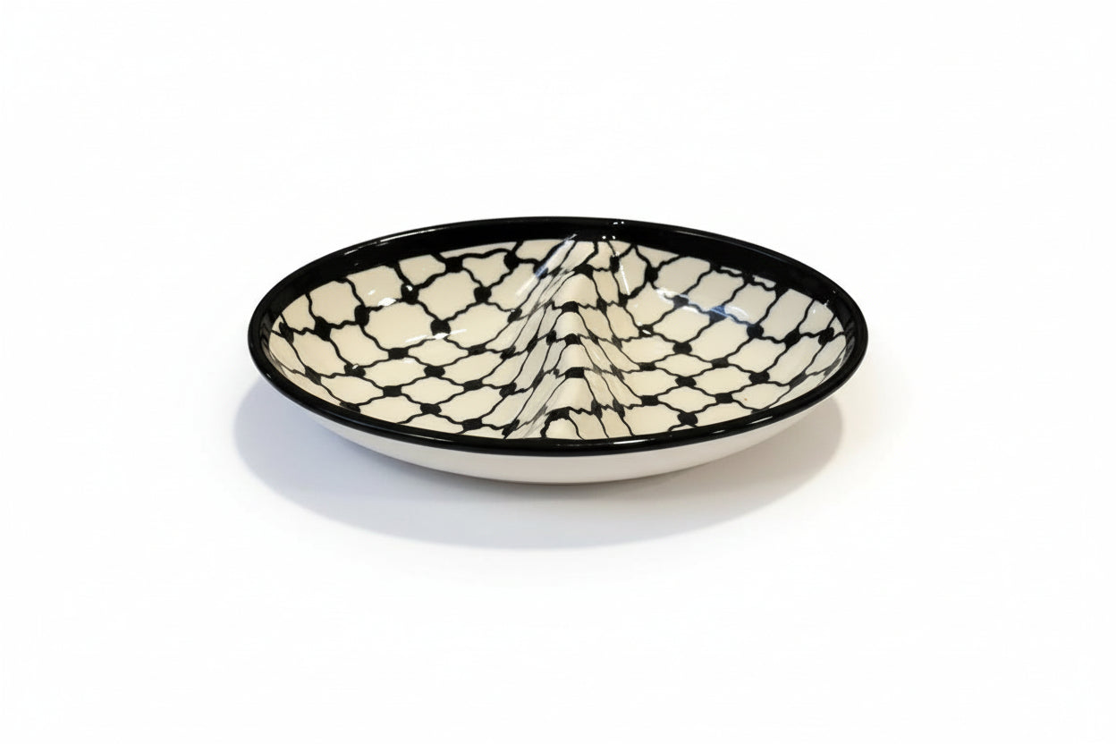 Round ceramic dish with black and white pattern on a gray surface