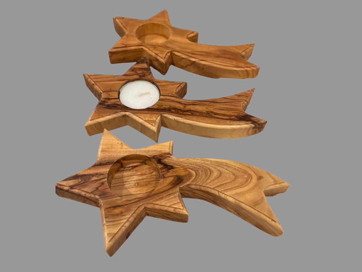 Handcrafted olive wood shooting star candle holders made in Bethlehem, Palestine, featuring natural wood grain and space for a tealight candle.