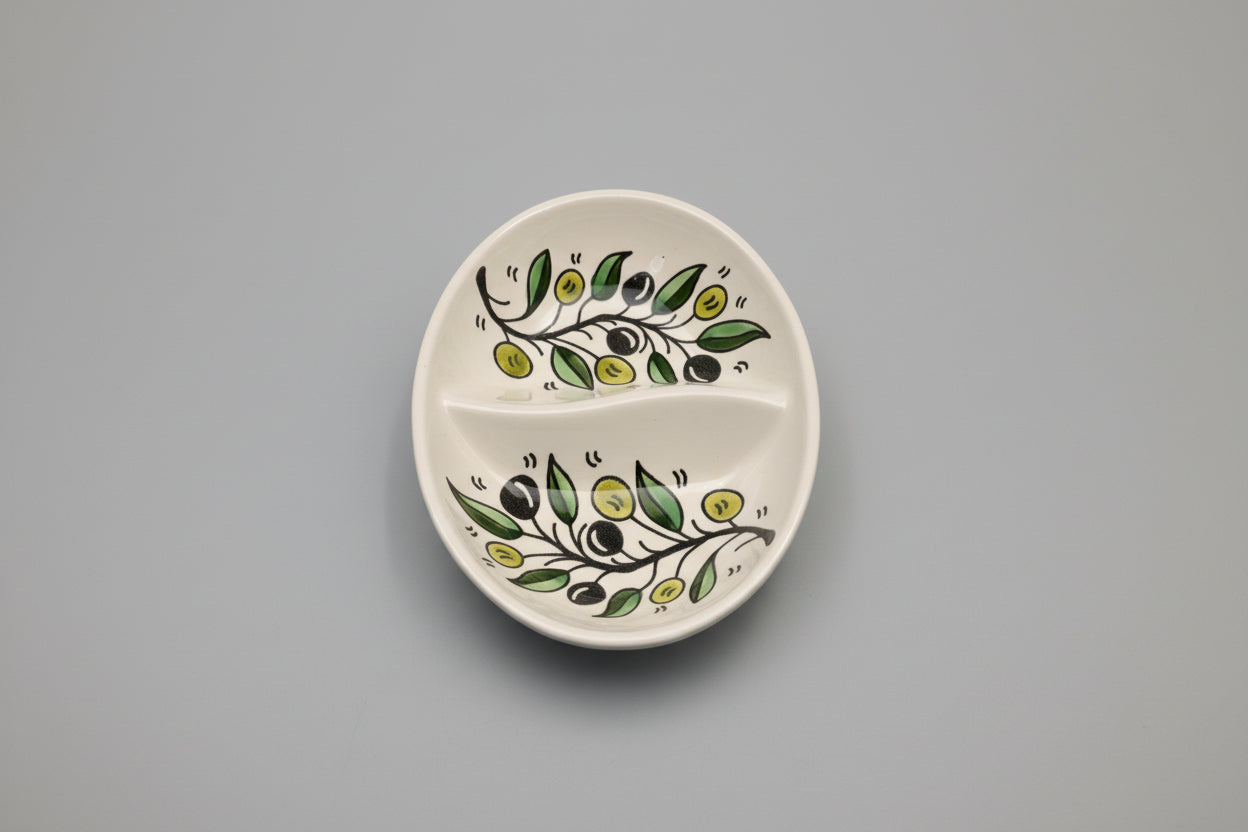 Ceramic dish with olive design on a gray surface
