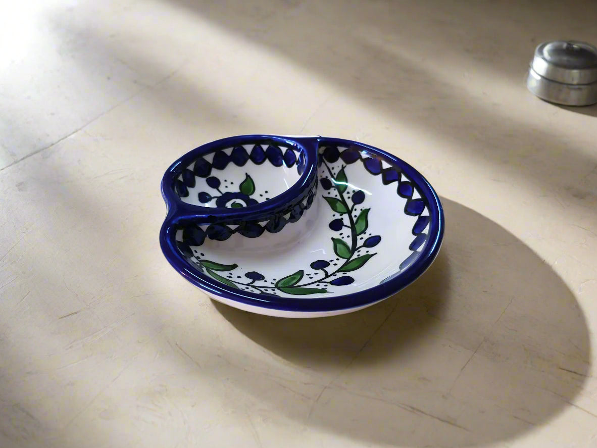 Ceramic dish with blue and green patterns on a beige surface