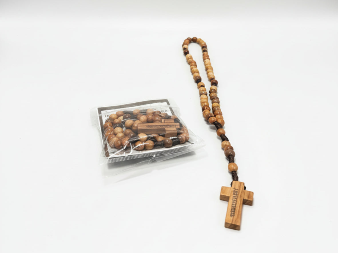 Wooden rosary with cross on a white background from holy land