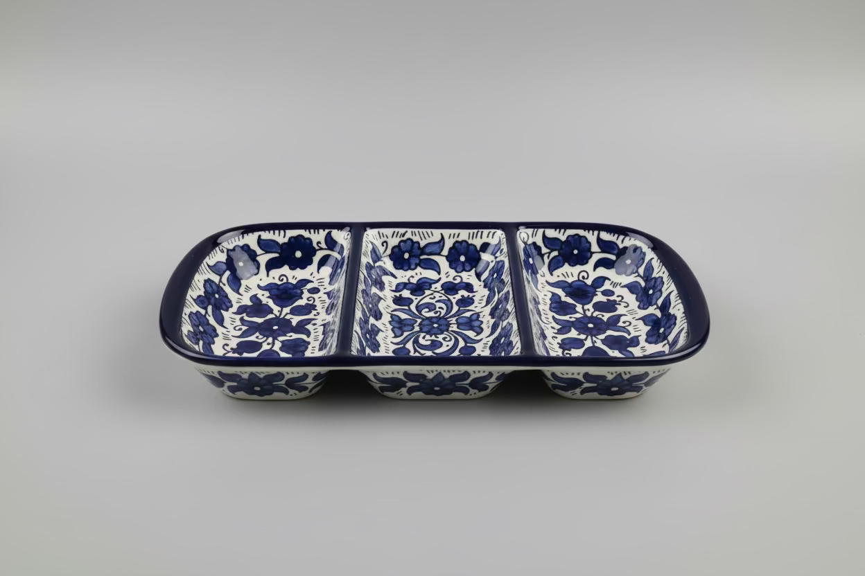 Three blue floral-patterned pot holders on a wooden surface