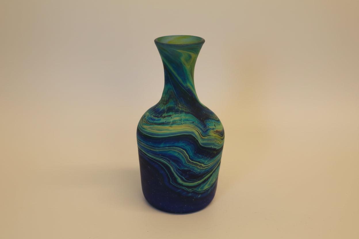 Decorative vase with blue and green swirl pattern on a white background
