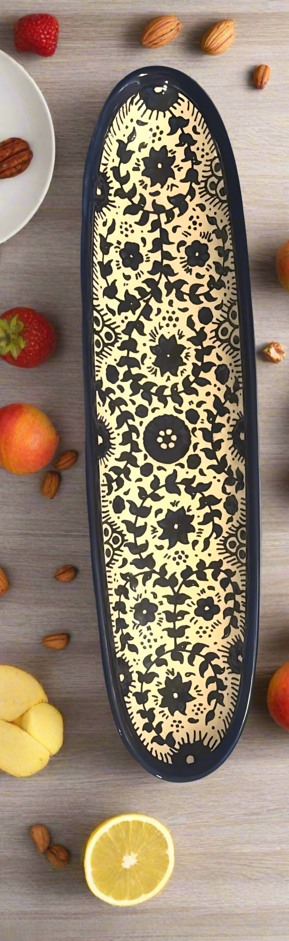 Decorative object with black floral pattern on a blue surface