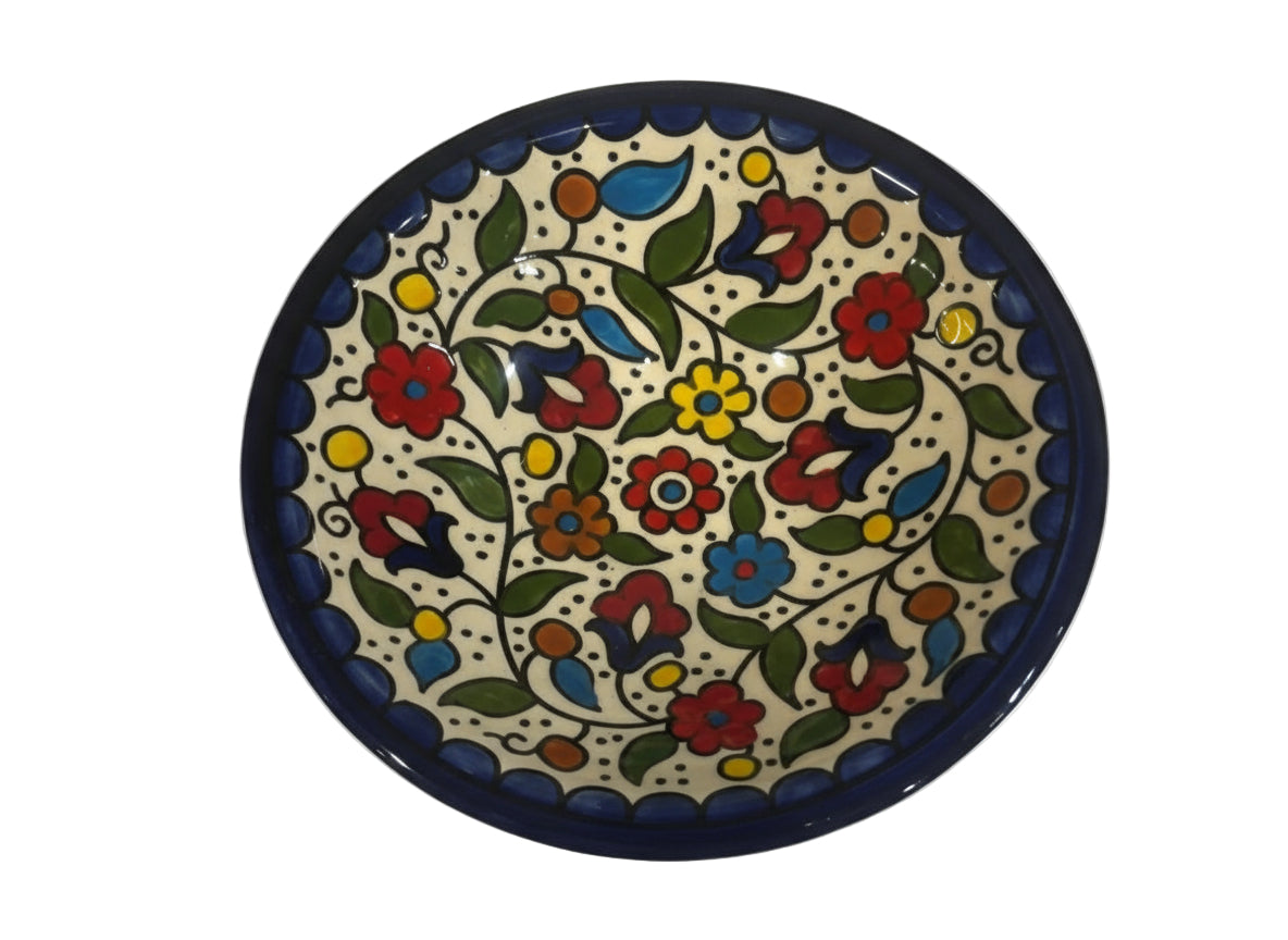 Decorative ceramic plate with floral patterns on a white background