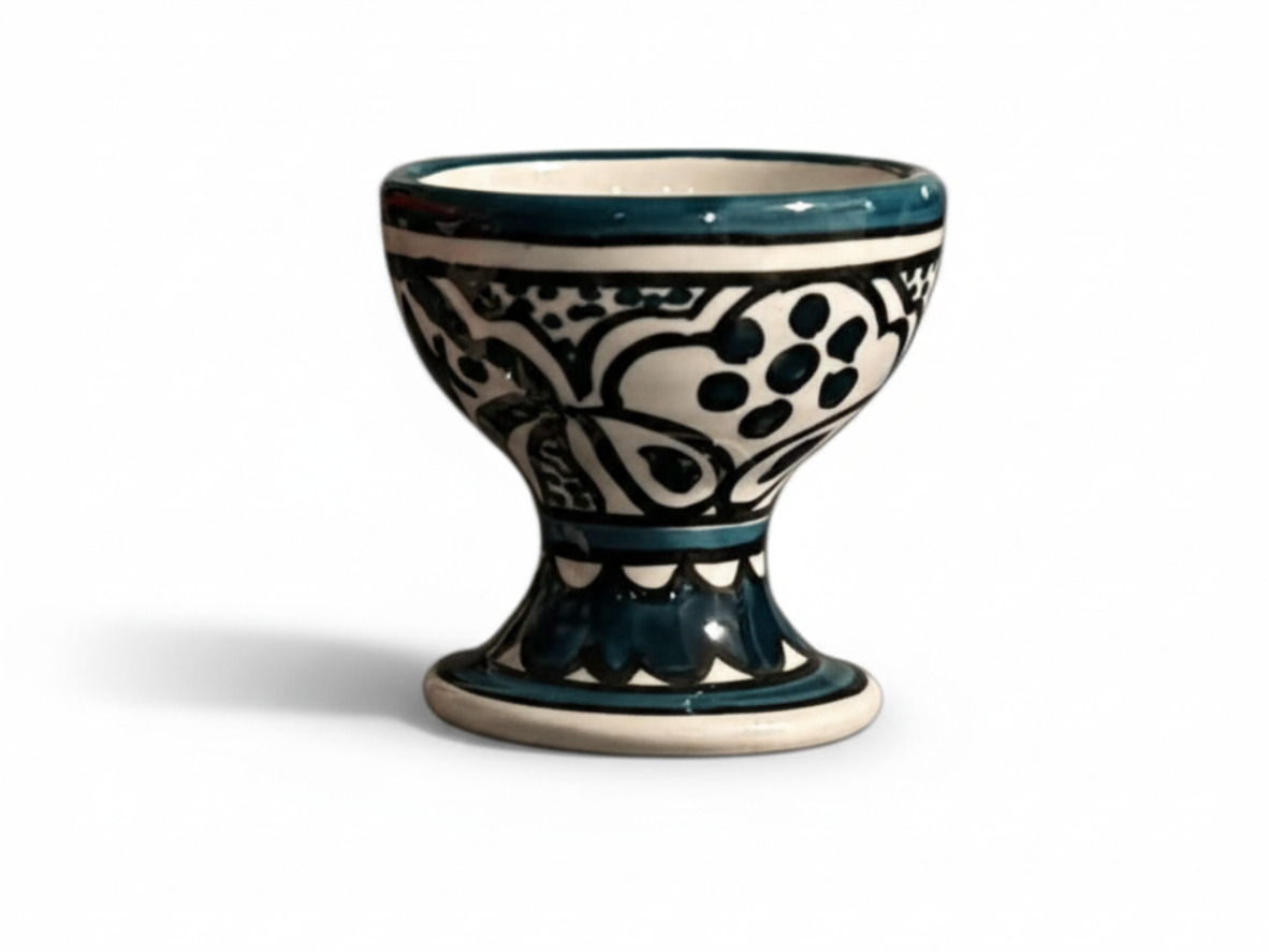 Ceramic egg cup with black and white pattern on a white background