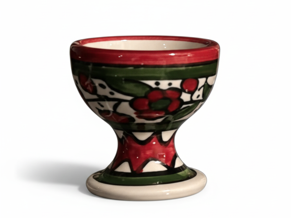 Ceramic egg cup with floral design on a white background